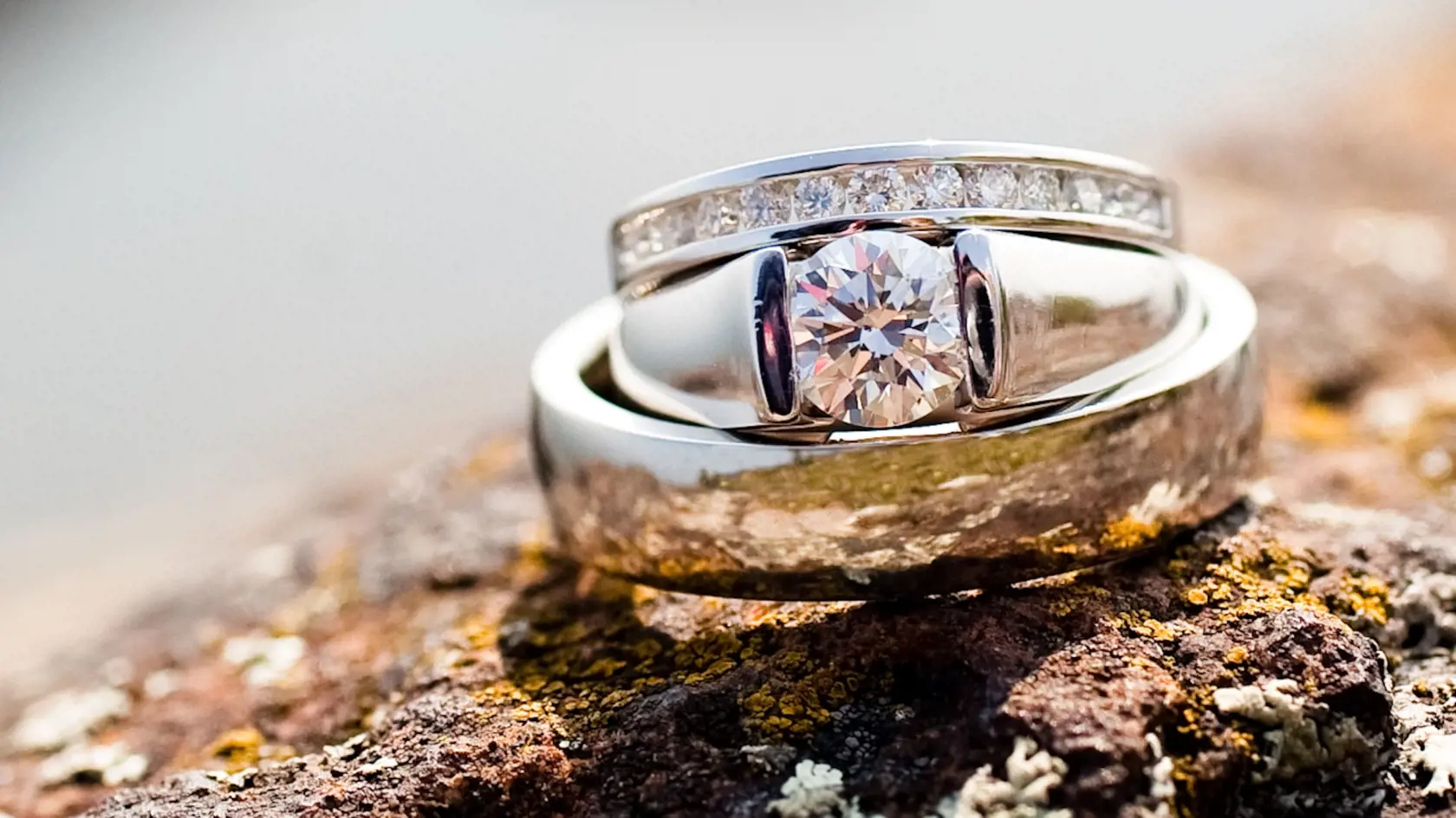 Wedding rings stacked on top of a rock.