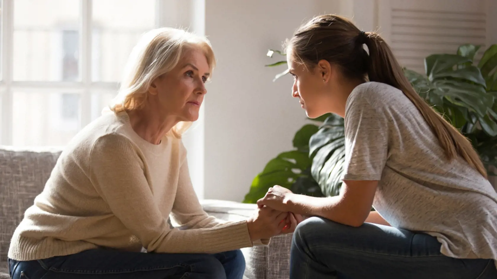 Grown,Up,Daughter,Holding,Hands,Of,Middle,Aged,Mother,Relatives