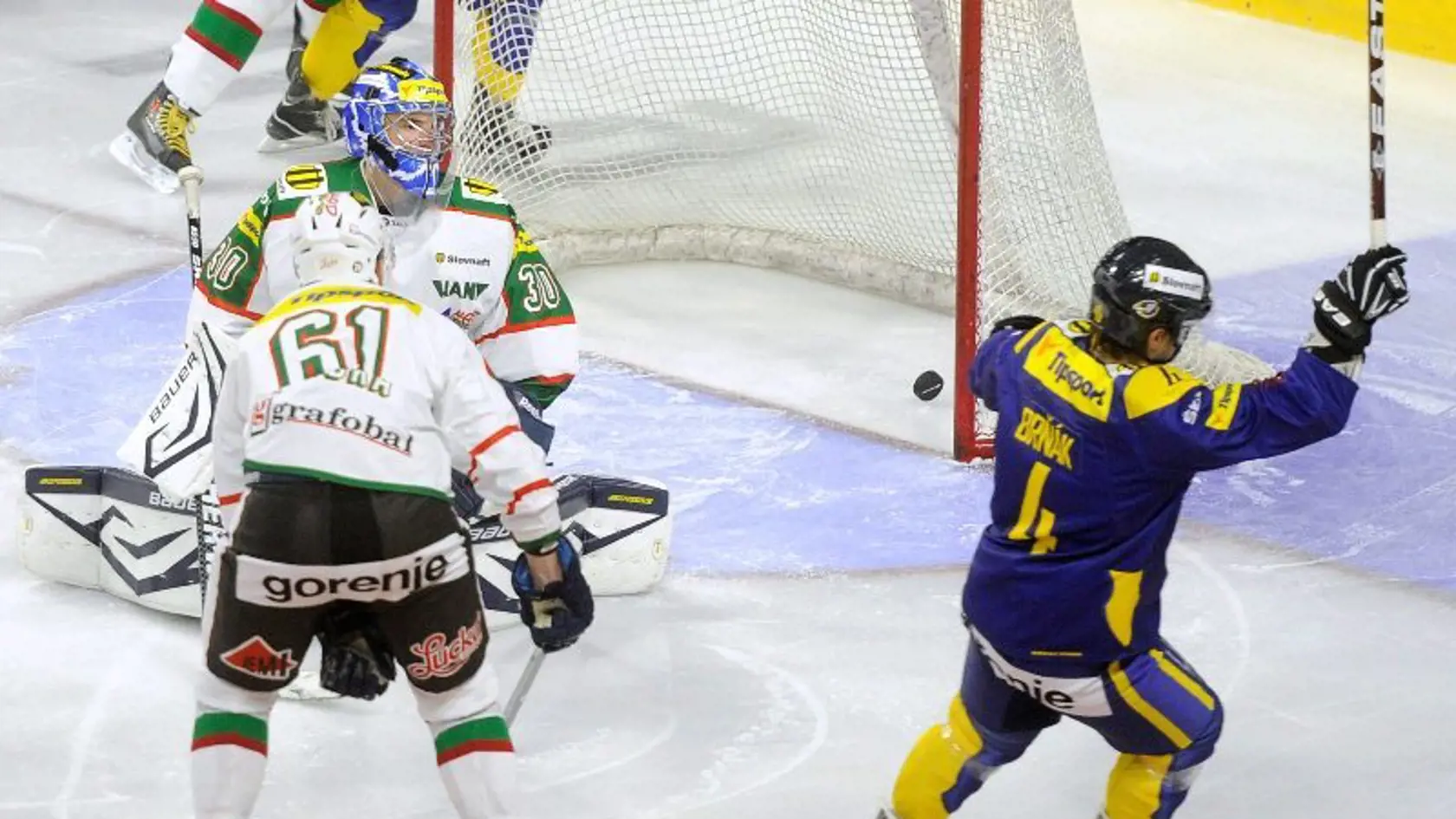 Hráč Piešťan Tomáš Brňák (vpravo) strieľa v 27. sekunde úvodný gól stretnutia do brány Skaličana Adama Trenčana v zápase 2. kola hokejovej Tipsport extraligy ŠHK 37 Piešťany - HK 36 Skalica.