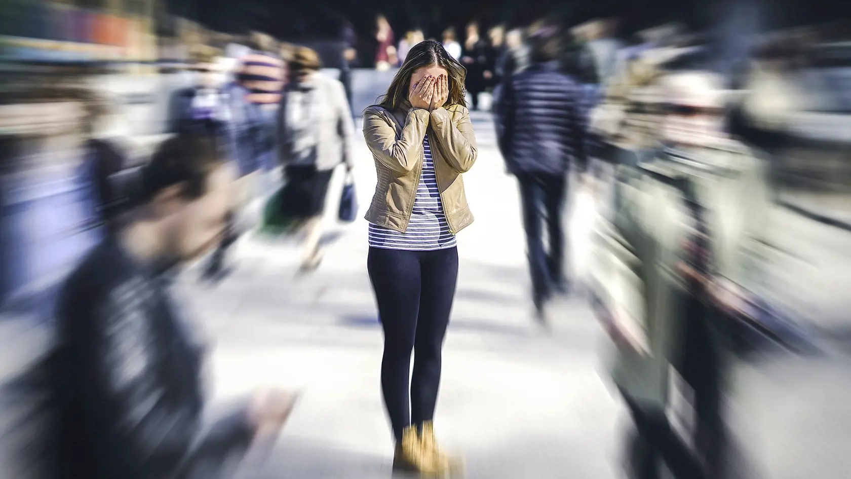 Panic attack in public place. Woman having panic disorder in city. Psychology, solitude, fear or mental health problems concept. Depressed sad person surrounded by people walking in busy street.