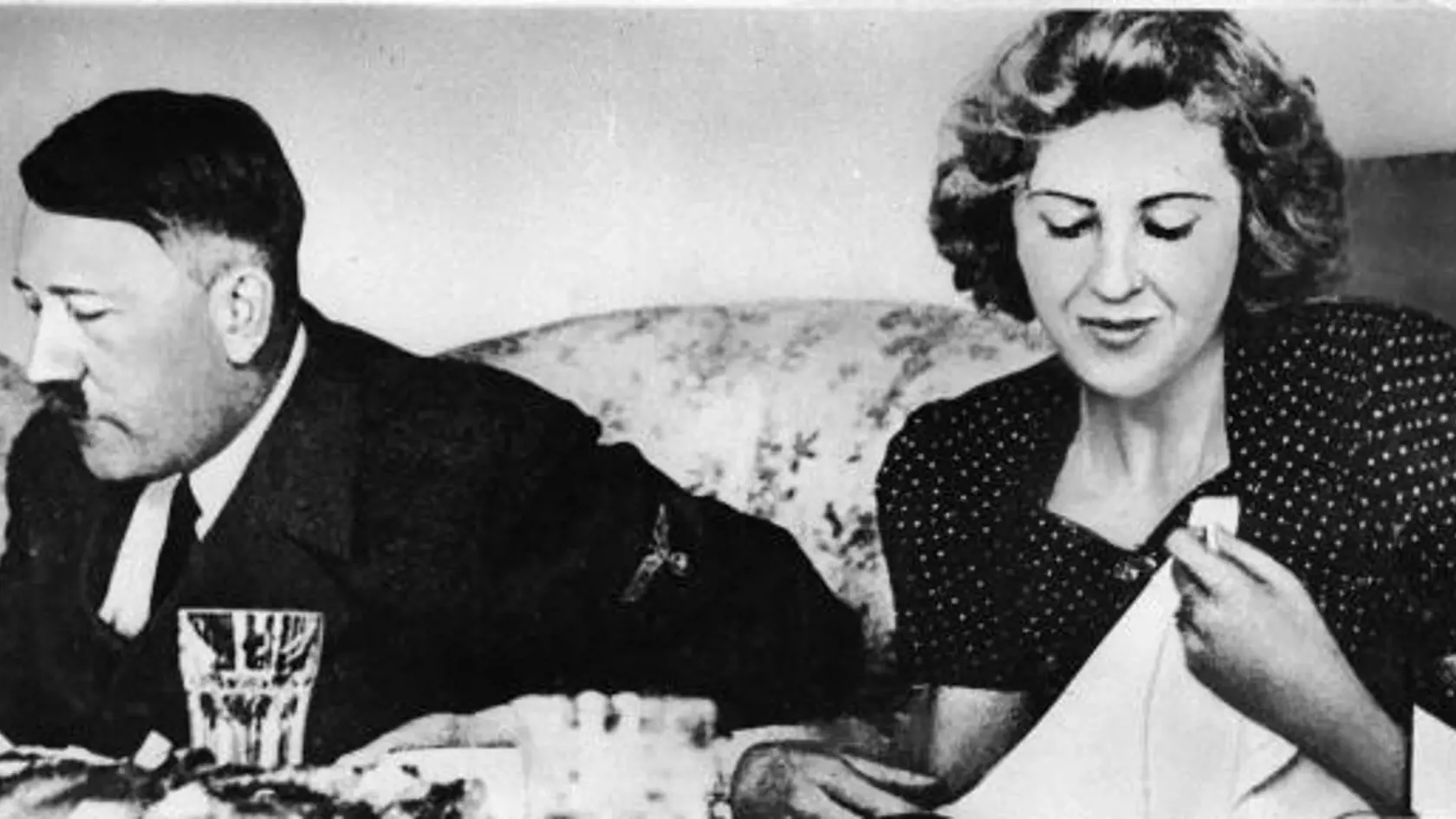 German dictator Adolf Hitler (1889 - 1945) and his mistress Eva Braun (1912 -1945) dine in a still from a private home movie made by Braun's sister Gretl Fegelein, early to mid 1940s. Hitler and Braun married on April 29, 1945, the day before they committed suicide. (Photo by Express Newspapers/Getty Images) 