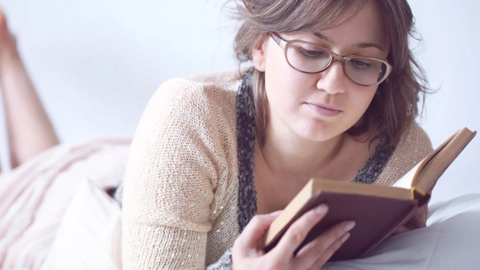 Woman in glasses reading a book