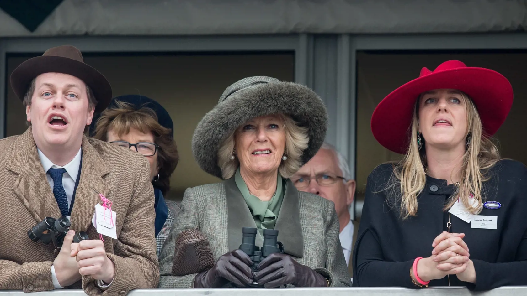 CHELTENHAM, ENGLAND - MARCH 11:  Camilla, Duchess of Cornwall (C) watches a race from the temporary Royal Box with her son Tom Parker Bowles and daughter Laura Lopes on the second day of the Cheltenham Festival on March 11, 2015 in Cheltenham, England.  (Photo by Matt Cardy - WPA Pool/Getty Images)