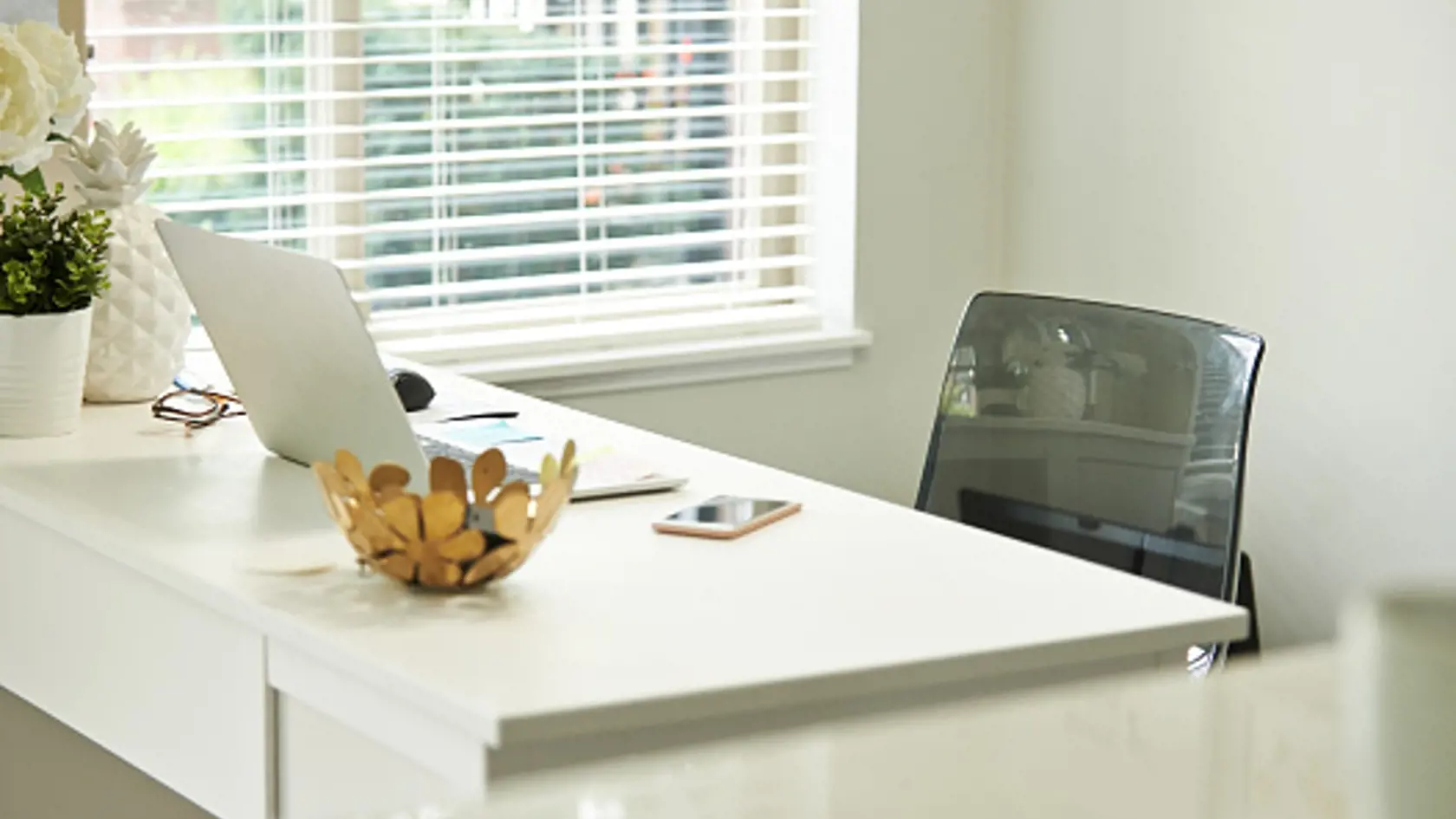 Shot of a laptop on a desk in a home study