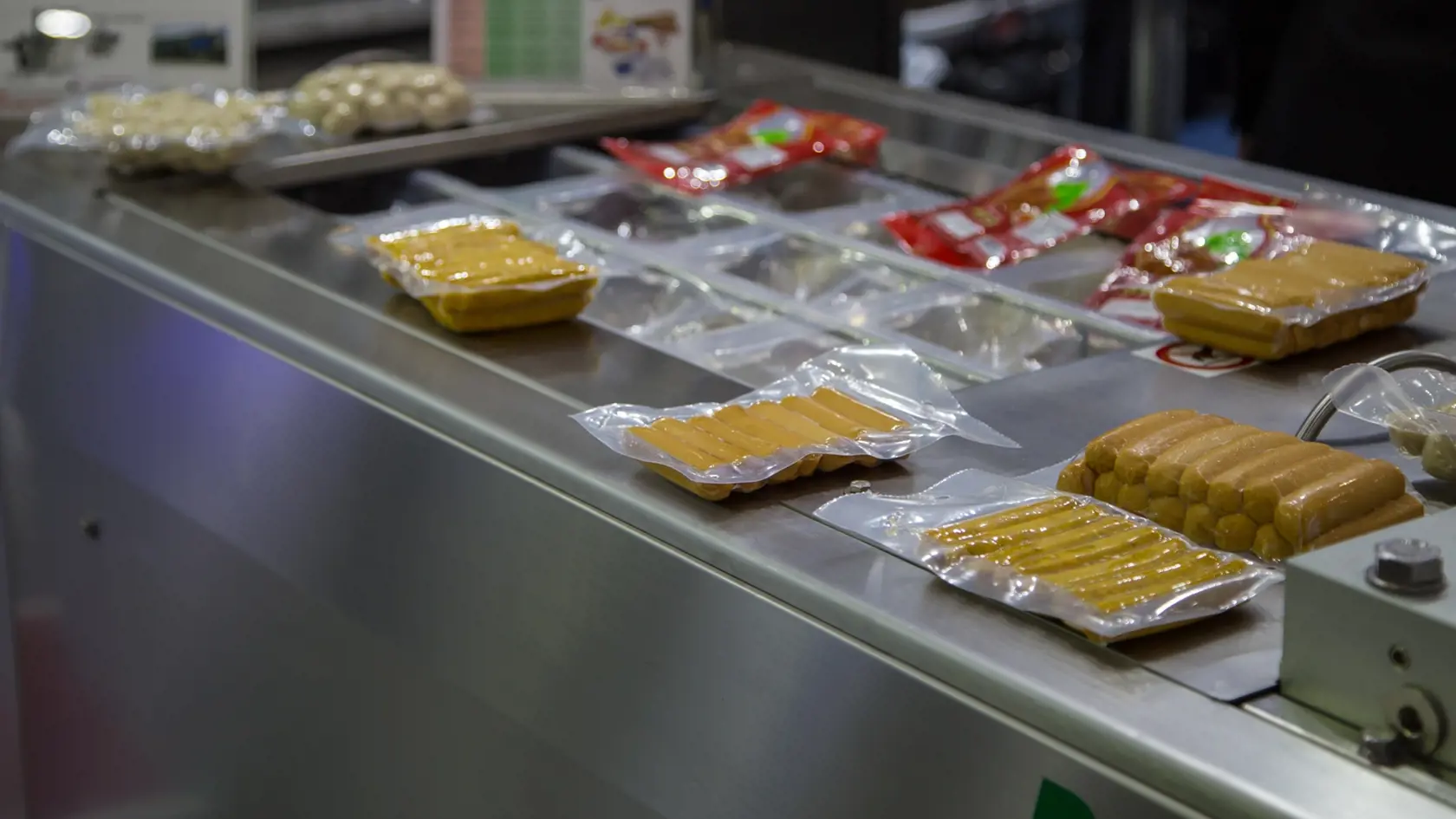 Packing,Of,Food,Sausage,In,Production,Line