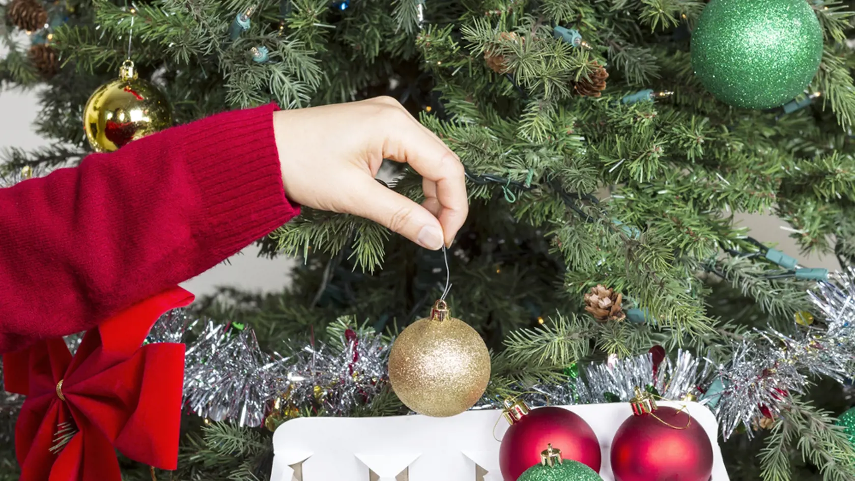 Female,Hand,Putting,Away,Golden,Holiday,Ornament,Into,White,Card