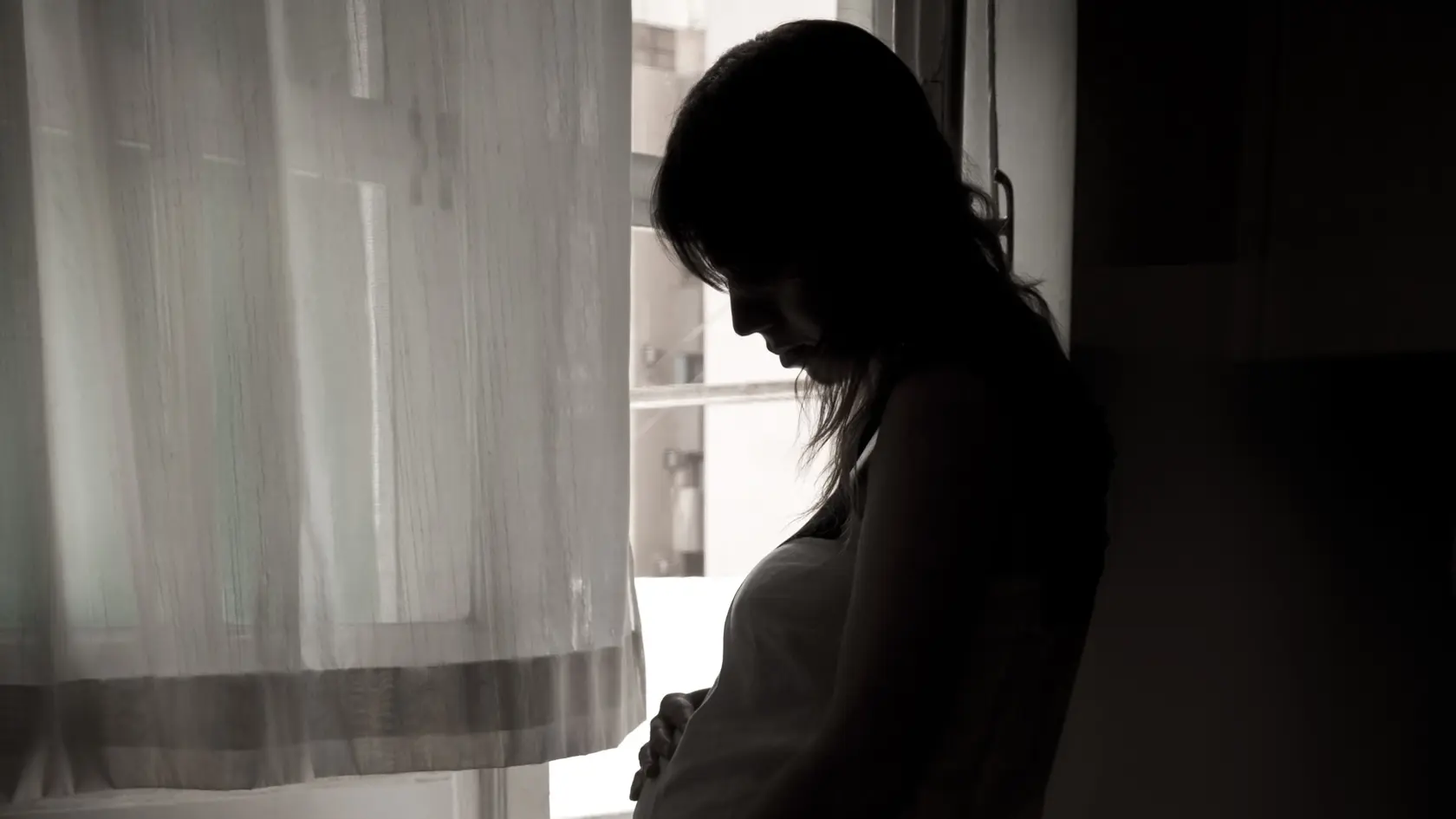 The pregnant young women  in bedroom.