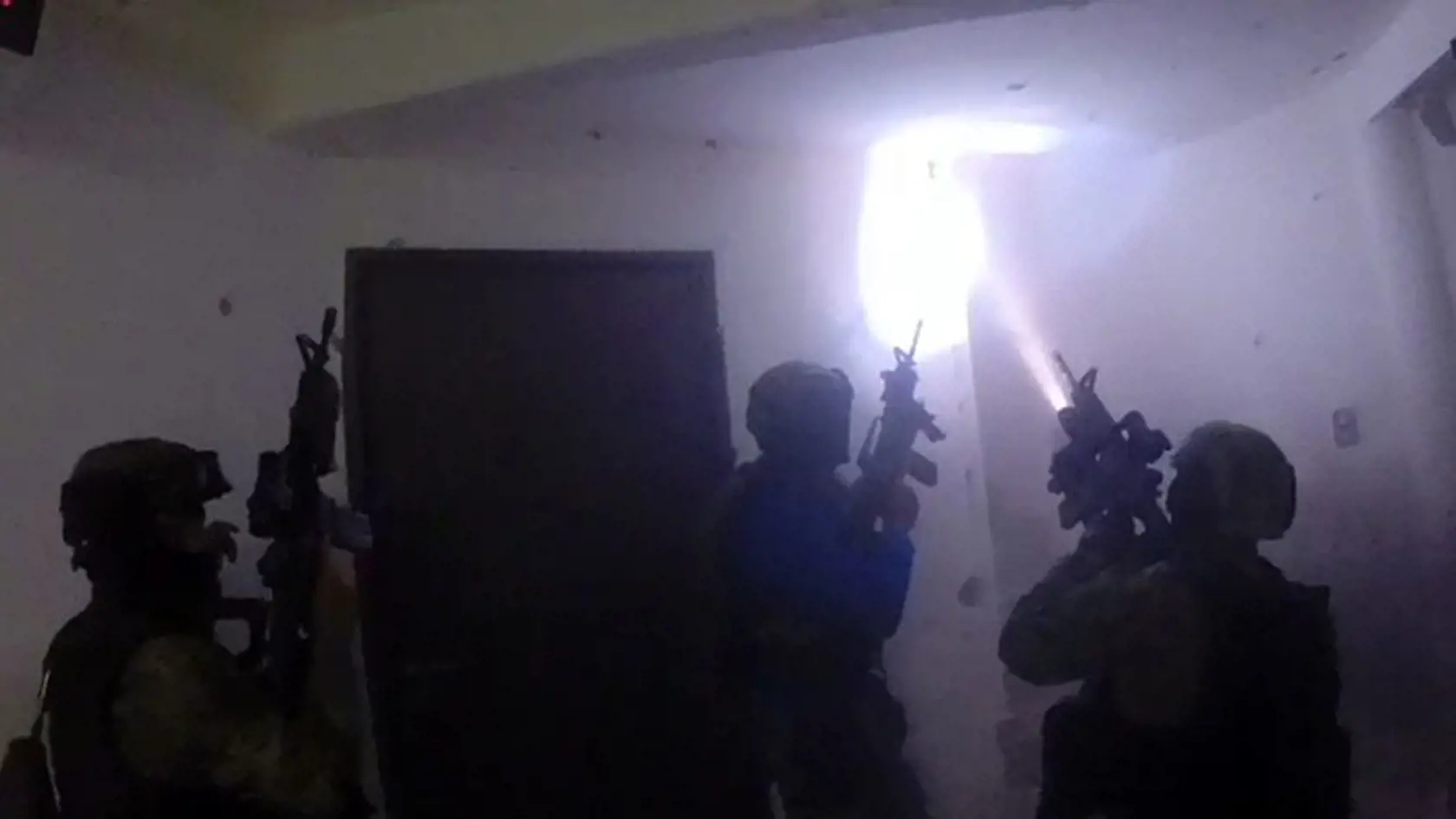 This frame-grab taken from Jan. 8, 2016 video released by Mexico's presidential press office, shows Mexican navy marines storming a home during the operation to recapture Mexico's most wanted drug kingpin, Joaquin "El Chapo" Guzman in Los Mochis, Mexico. Mexico has begun the process of extraditing Guzman to the United States, where he faces drug-trafficking charges, but that could take "a year or longer" because of legal challenges, said the head of Mexico's extradition office, Manuel Merino. He