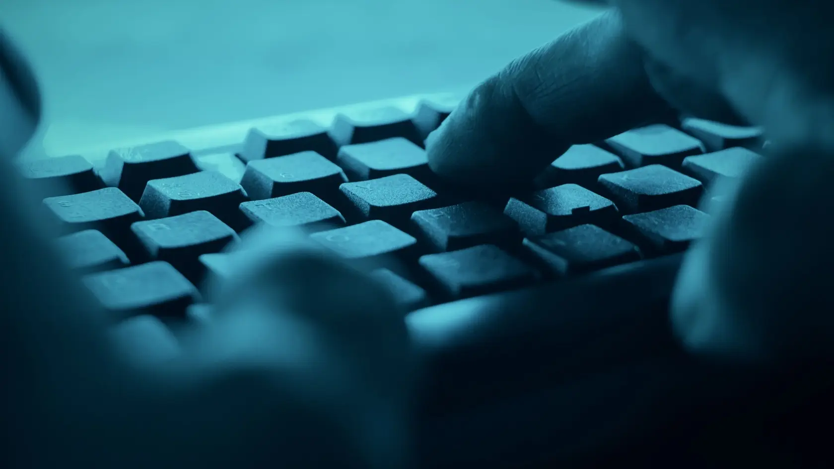 Hands typing on desktop pc computer keyboard