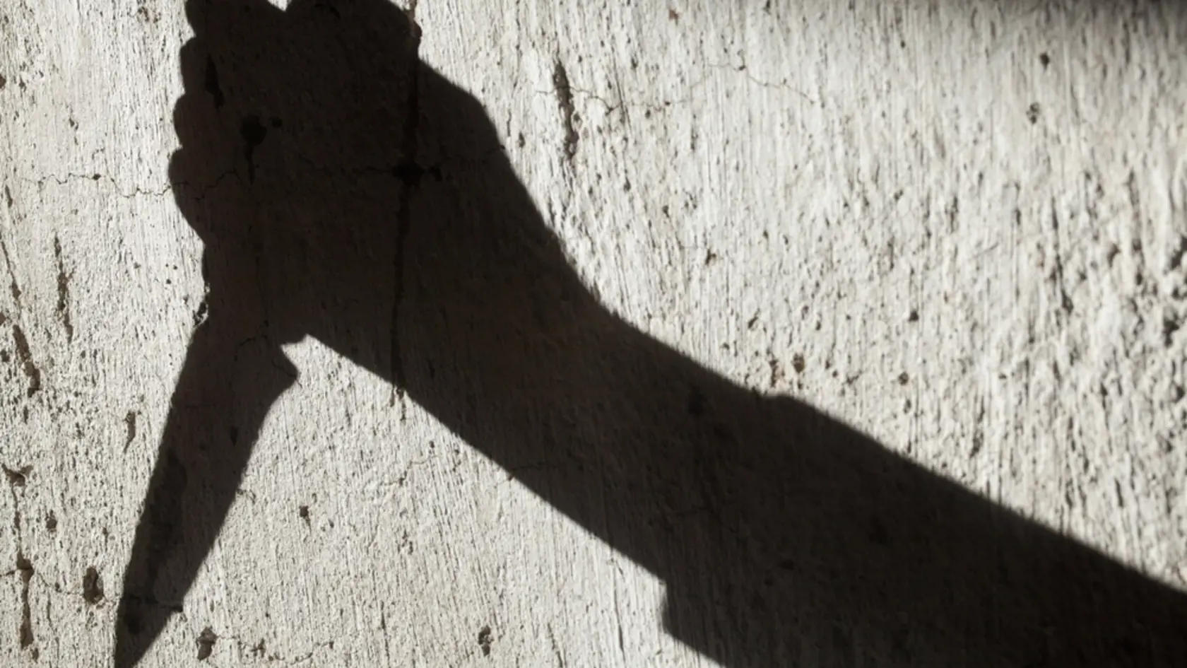 Shadow,Of,The,Hand,Holding,A,Big,Sharp,Knife.,Murderer,