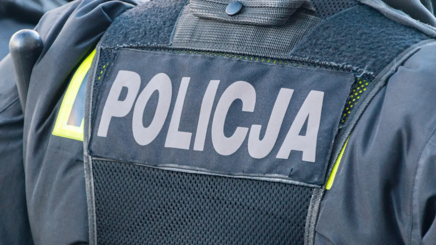Back of polish policeman and inscription policja.