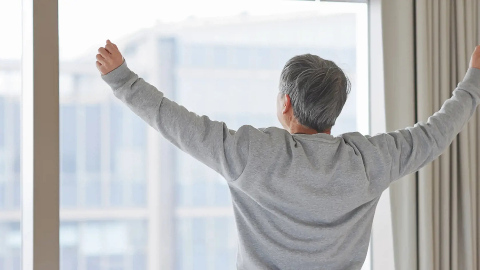 Asian,Elderly,Man,Wake,Up,And,Stretch,His,Arm,In