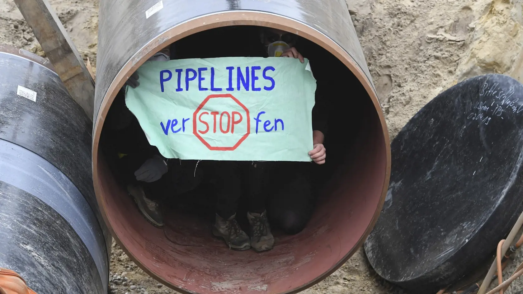 Activists occupy a German pipeline in Wrangelsburg, northern Germany, Thursday, May 16, 2019. Police say activists have occupied a building site in northern Germany to protest against the ongoing Nord Stream 2 pipeline project with Russia. (Stefan Sauer/dpa via AP)