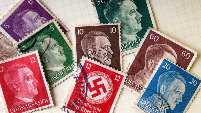 Old German Third Reich postage stamps from the second world war with Adolph Hitler and the Nazi Swastika.